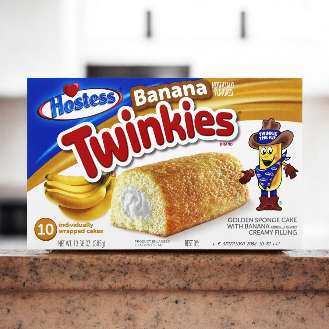 Hostess Banana Twinkies 385g, weiche Biskuitkuchen gefüllt mit cremiger Bananenfüllung, ideal als süßer Snack oder Dessert.